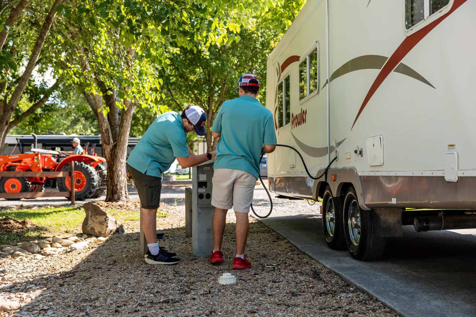 Two men are diligently working on a RV at the Big Meadows Campground.