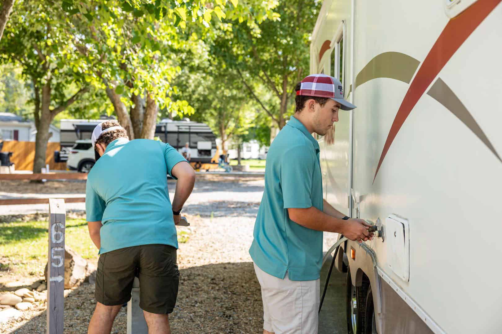 Two men plugging an RV into a power outlet at Big Meadows Campground.