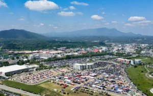 An aerial view of a parking lot with mountains in the background.